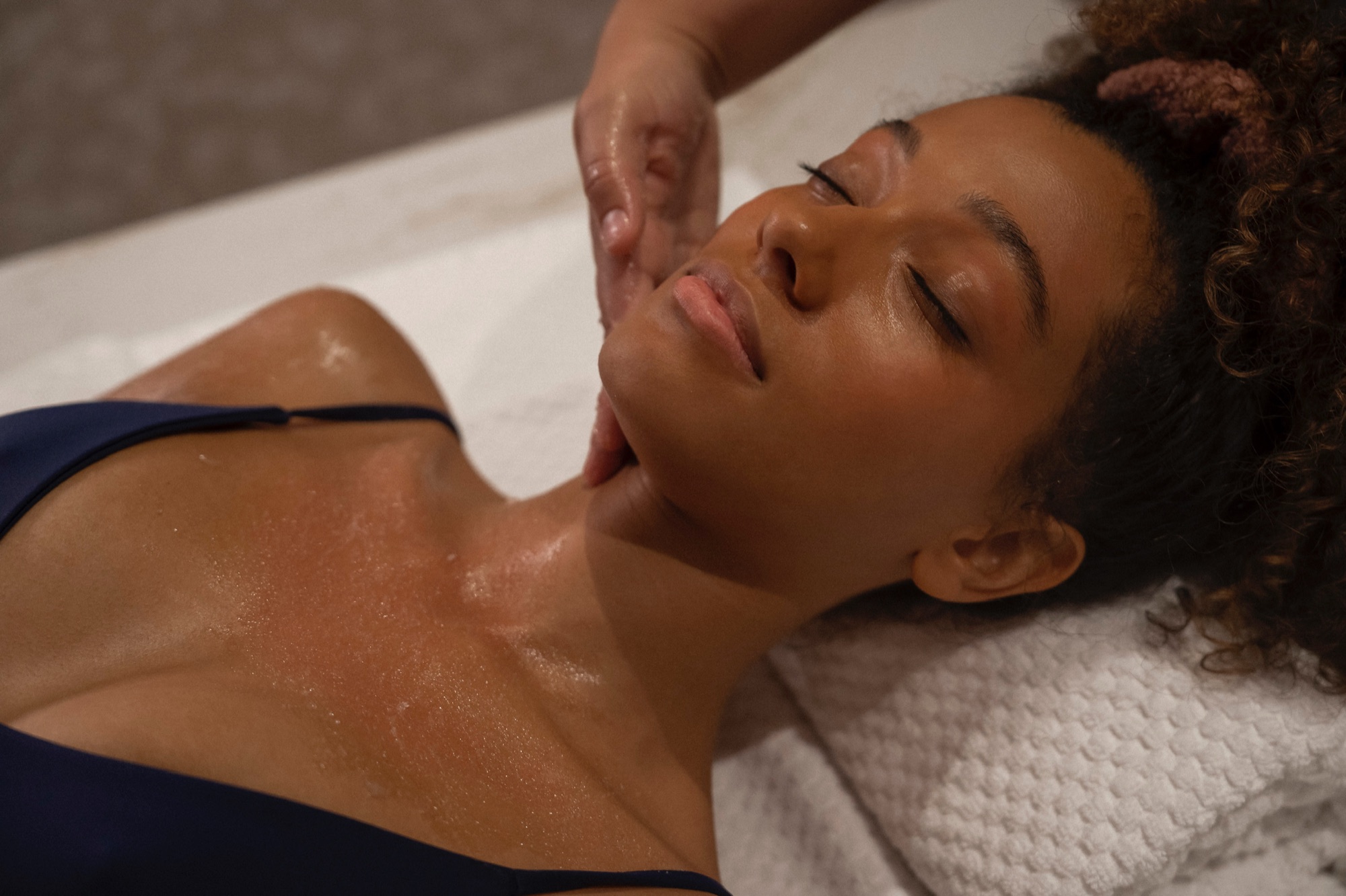 Guest relaxing during a skin-smoothing body treatment at World Spa, Brooklyn